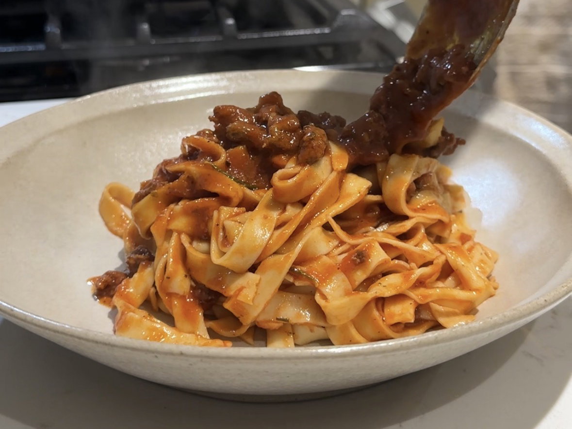 Homemade fettuccine with sausage ragu