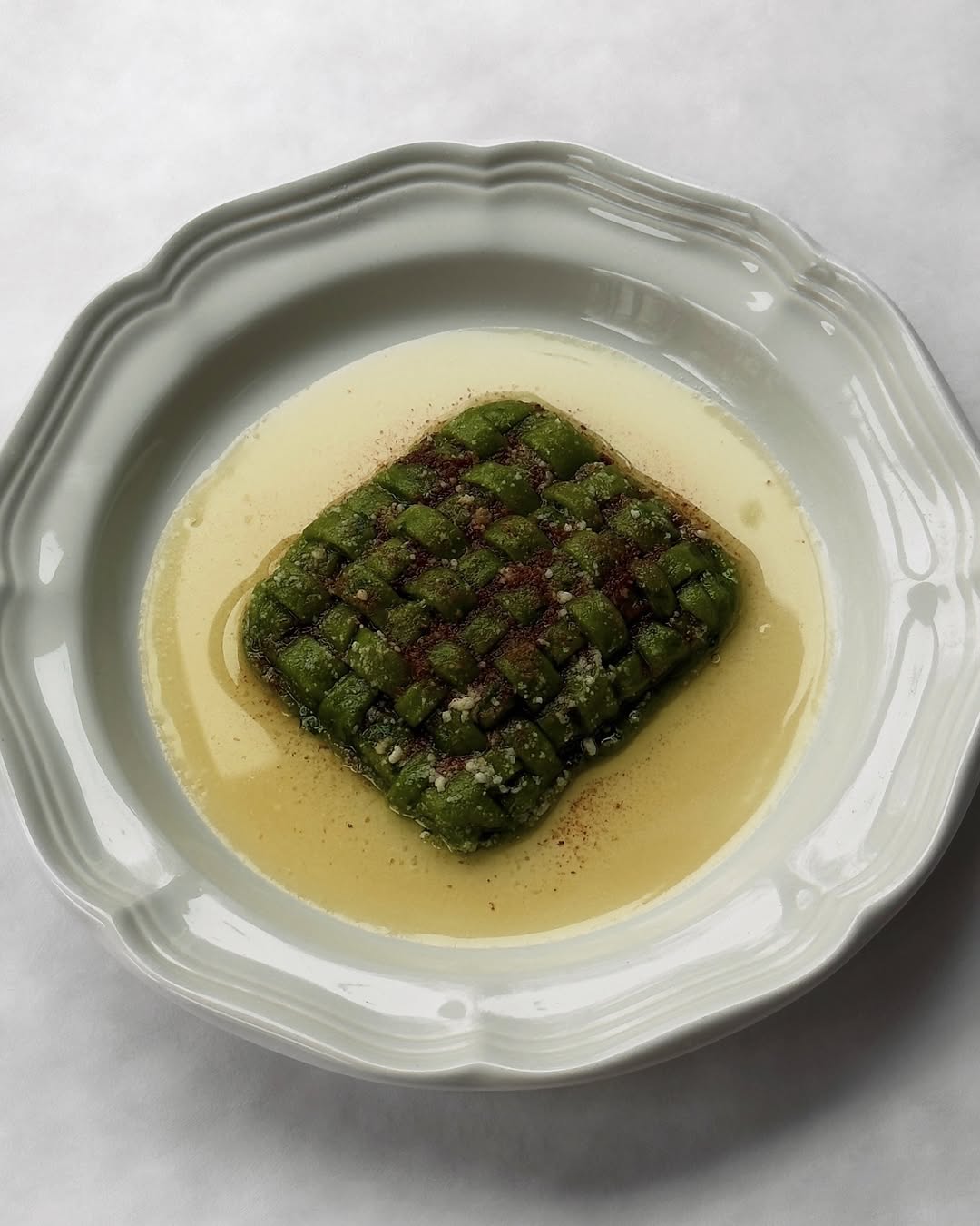 Woven Spinach Raviolo in a Brown Butter Parmesan Sauce